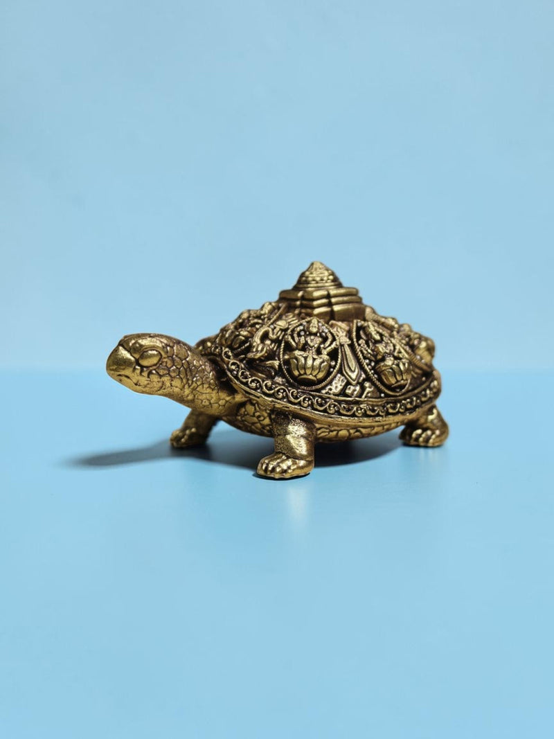 Rigvedaa™ brass tortoise statue featuring intricate Ashta Lakshmi engravings and a central Shree Yantra on its shell