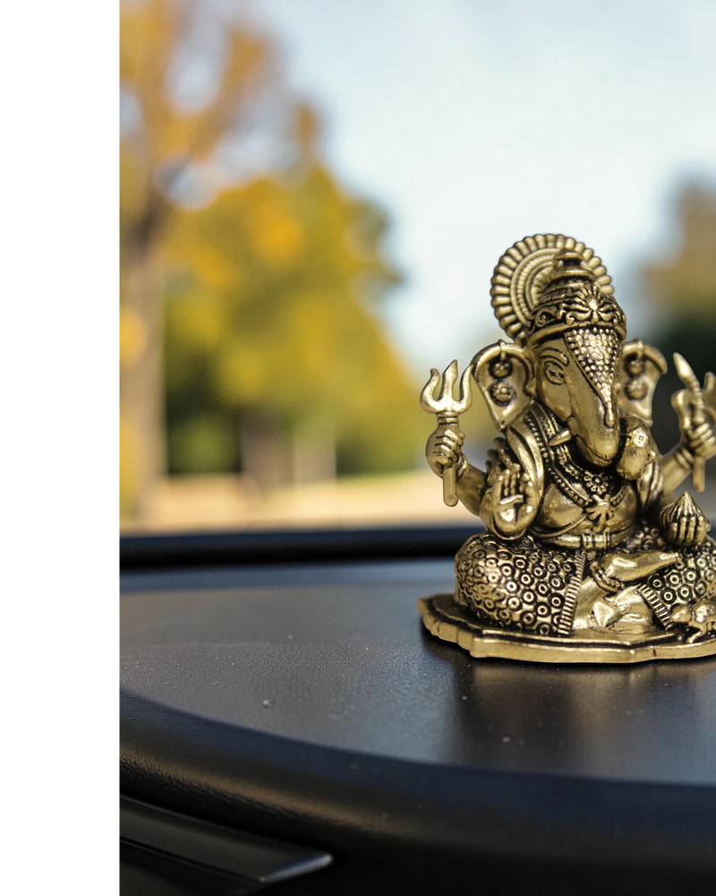 Rigvedaa™ brass Ganesha idol for car dashboard, detailed golden finish, holding trident, for good luck and protection.
