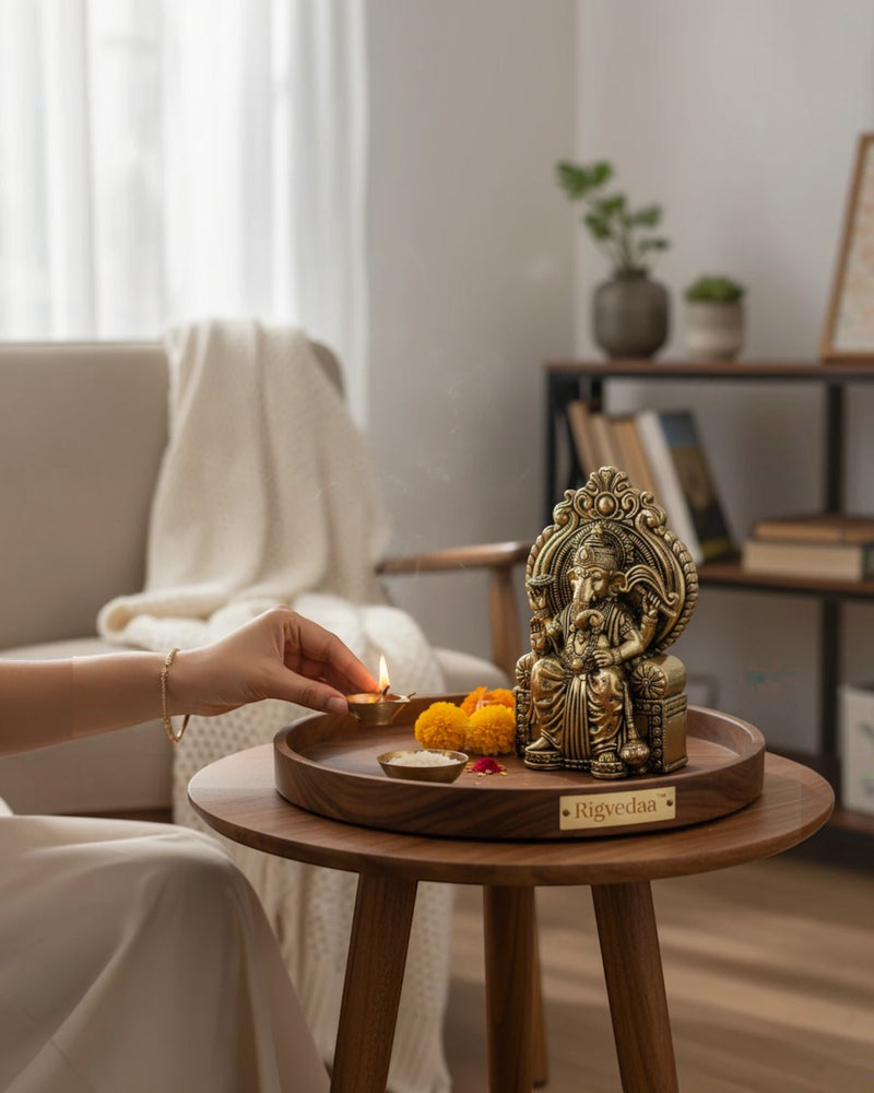Rigvedaa™ antique brass Ganesha statue seated on an ornate throne, with intricate details and a serene expression.