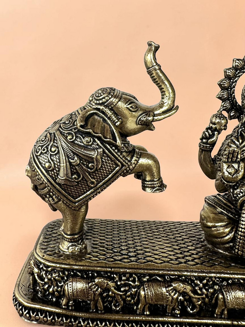 Rigvedaa™ antique bronze Goddess Lakshmi and elephant figurine with intricate ceremonial details on a textured base