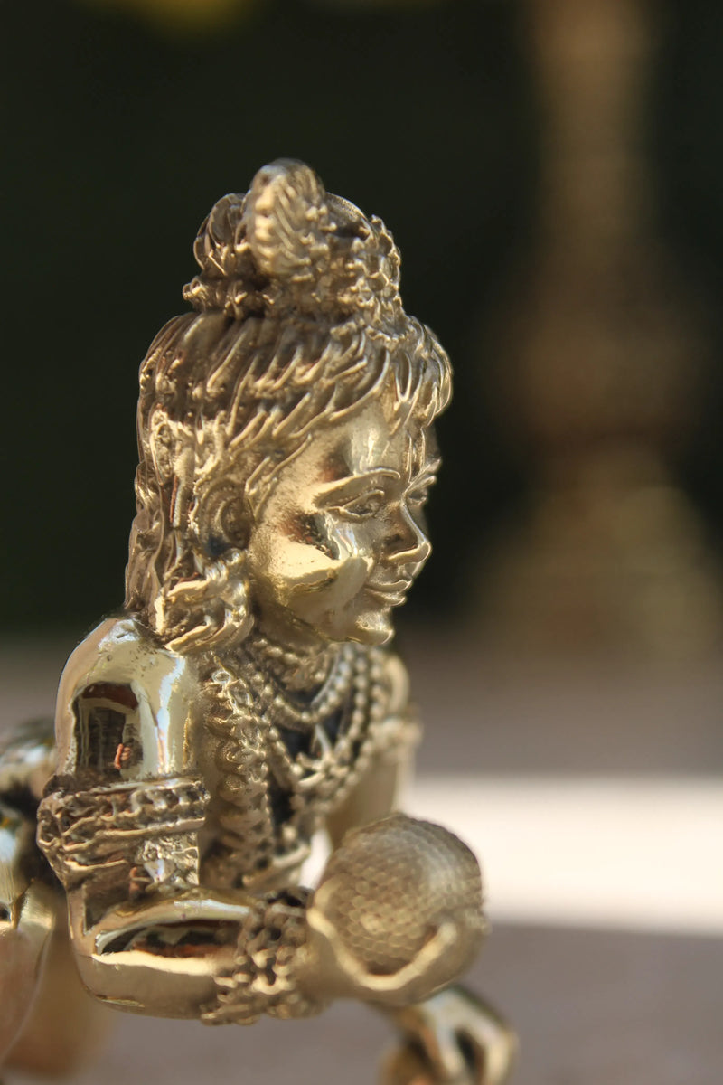 Brass Laddu Gopal Idol side profile view highlighting facial features and ornamental necklace details