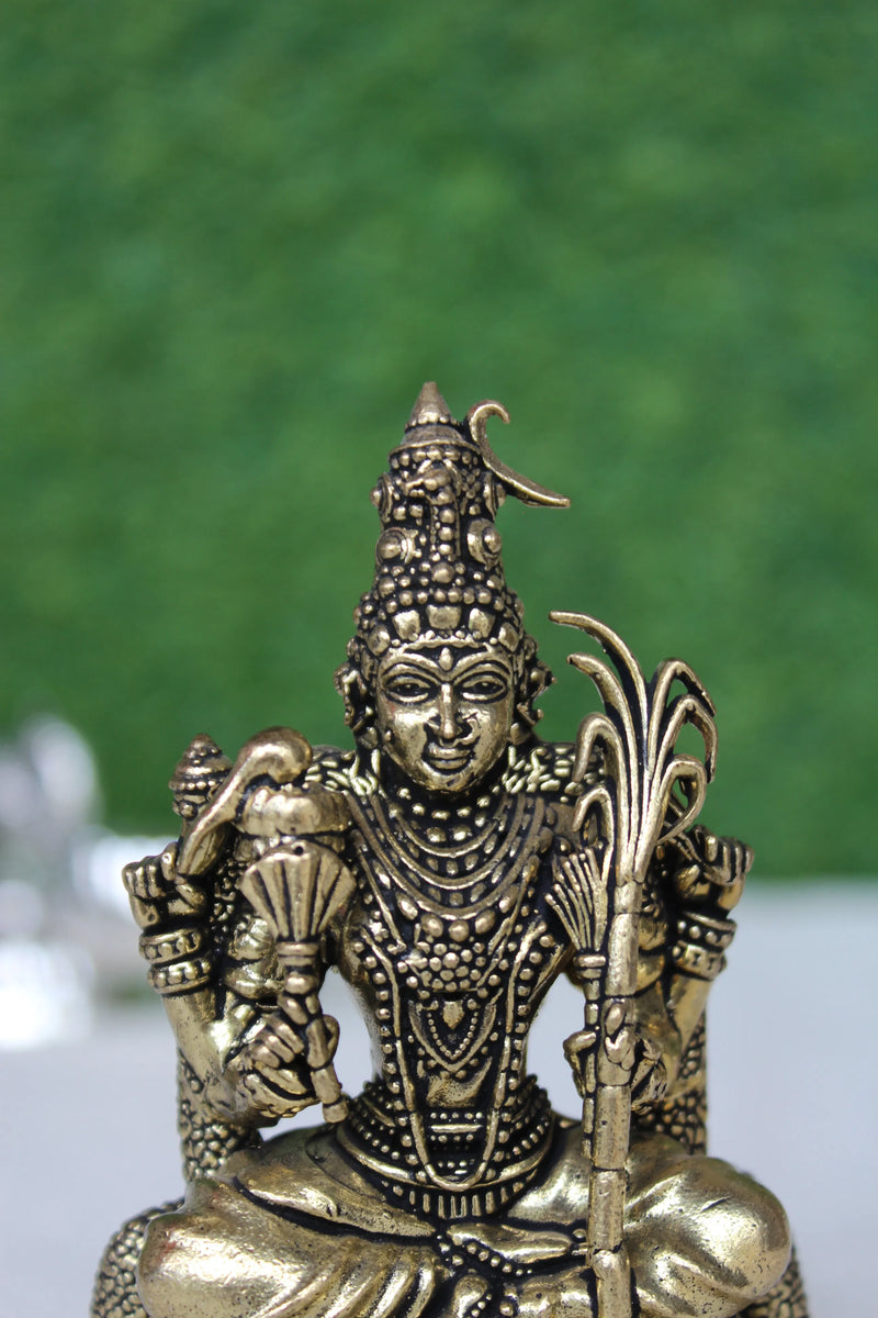 Close-up of Kamakshi Mata brass idol face and upper body – intricate facial features, traditional crown and ornaments on pure brass Goddess statue