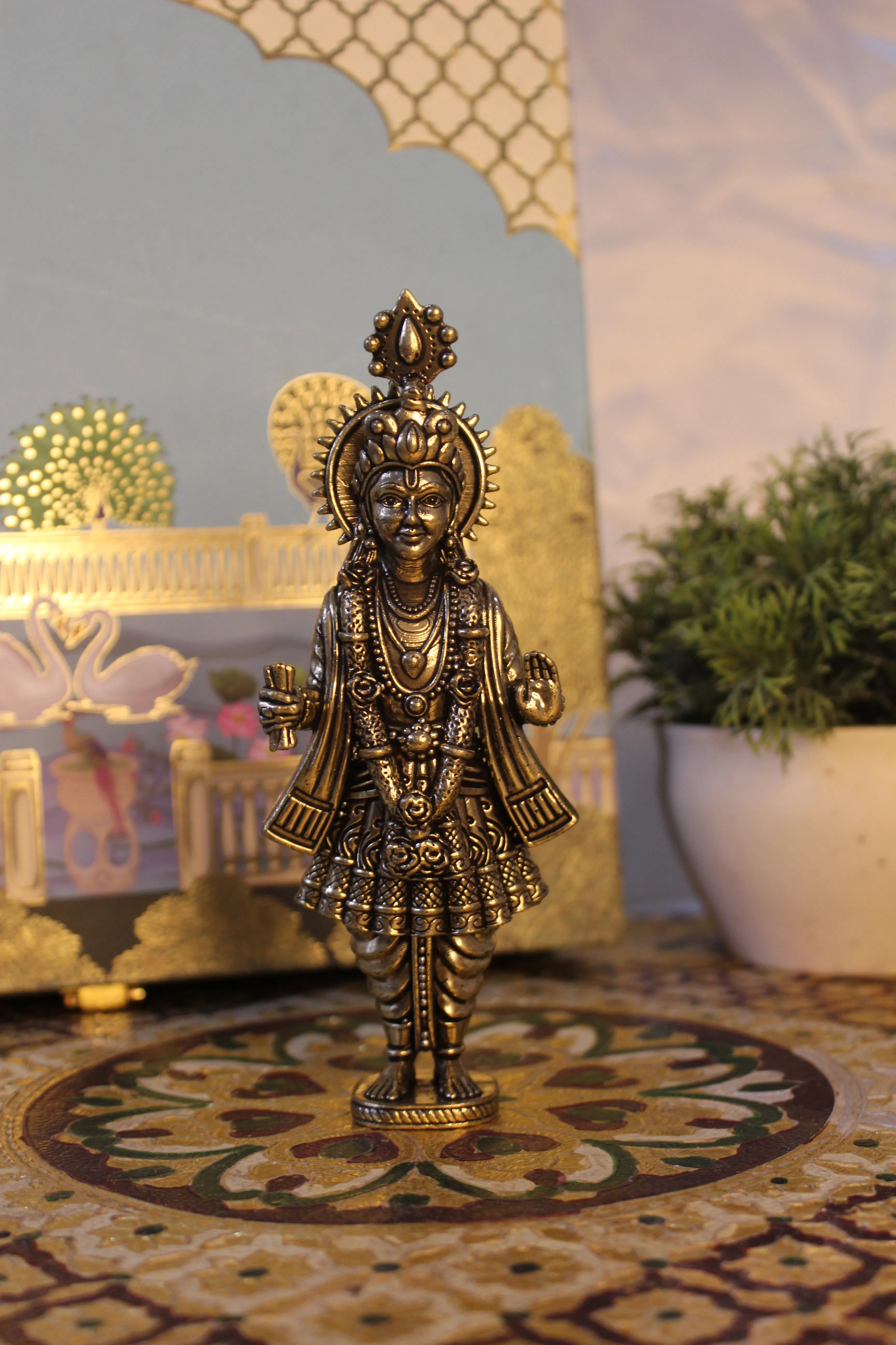 Front view of handcrafted brass Narayan Swami deity idol with intricate ornate crown and decorative halo in standing pose