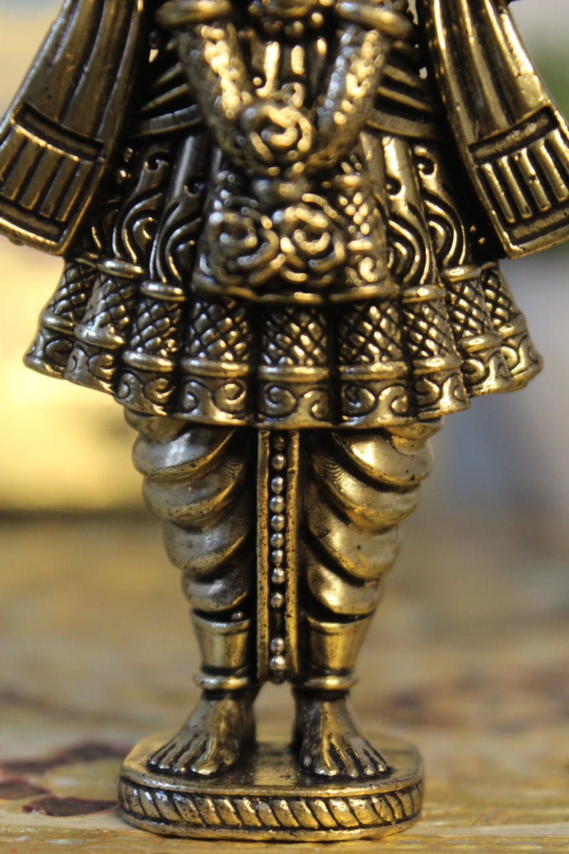 Lower body legs and decorative base of brass Narayan Swami deity idol showing fine carving and ornamental pedestal