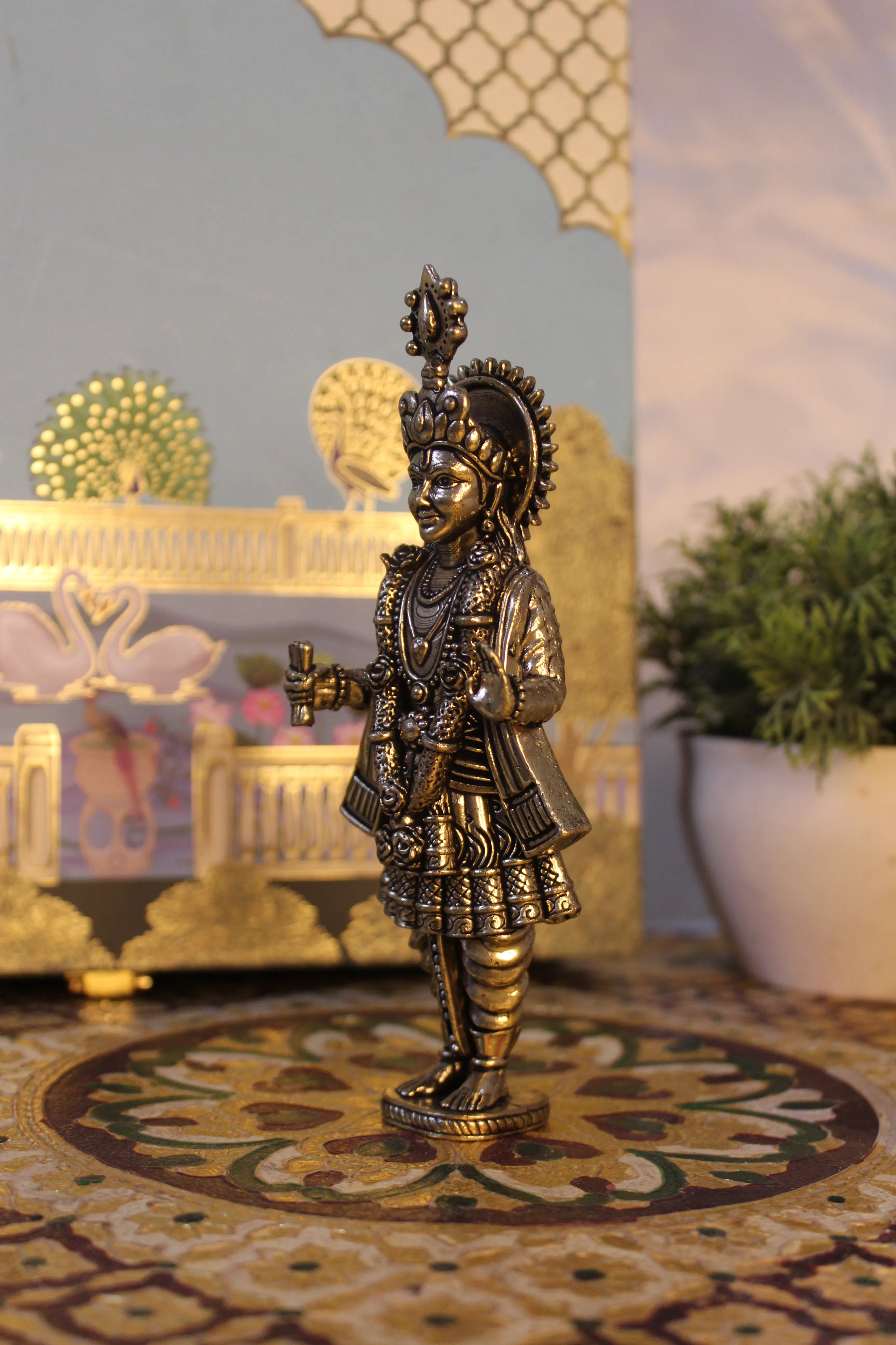 Side angle view of handcrafted brass Narayan Swami idol showing detailed body ornamentation and decorative elements