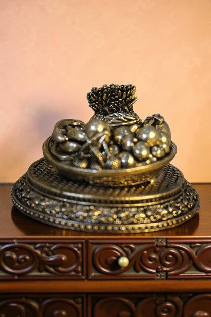 Rigvedaa™ antique brass fruit basket centerpiece with intricate base detailing, ideal for home decor and festive occasions.