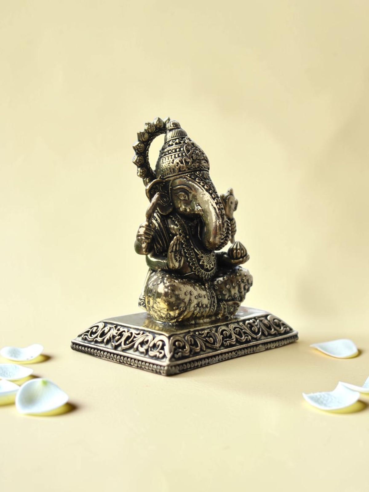 Rigvedaa™ antique gold finish Lord Ganesha idol with intricate engravings on a rectangular pedestal
