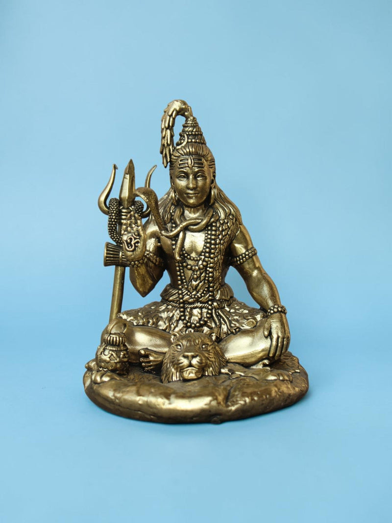 Rigvedaa™ antique gold Lord Shiva idol in a seated meditative pose with a trishul and tiger skin base.