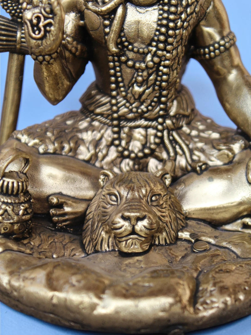 Rigvedaa™ antique gold Lord Shiva idol featuring intricate tiger skin base, Trishul, and detailed beadwork.