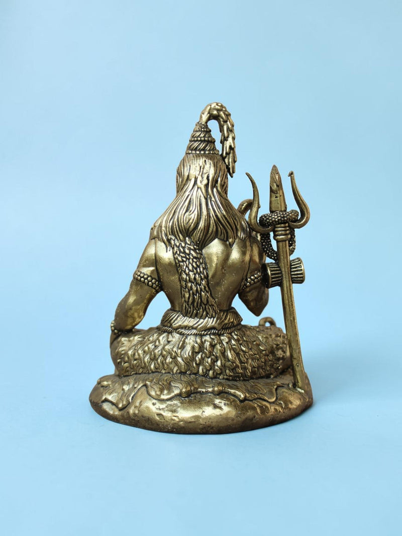 Rigvedaa™ antique gold Lord Shiva idol seen from behind, featuring a trishul, serpent, and tiger skin base.