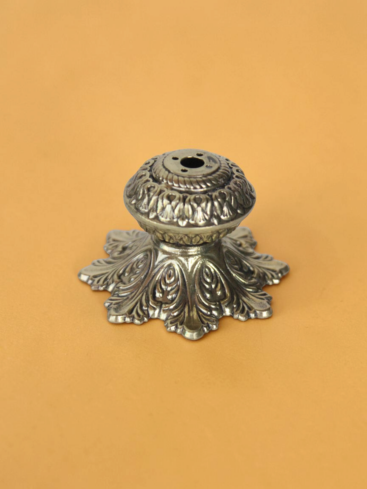 Rigvedaa™ solid brass agarbatti stand with an intricate floral petal base and antique golden finish for puja mandir.