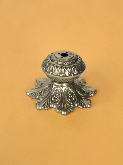 Rigvedaa™ solid brass agarbatti stand with an intricate floral petal base and antique golden finish for puja mandir.