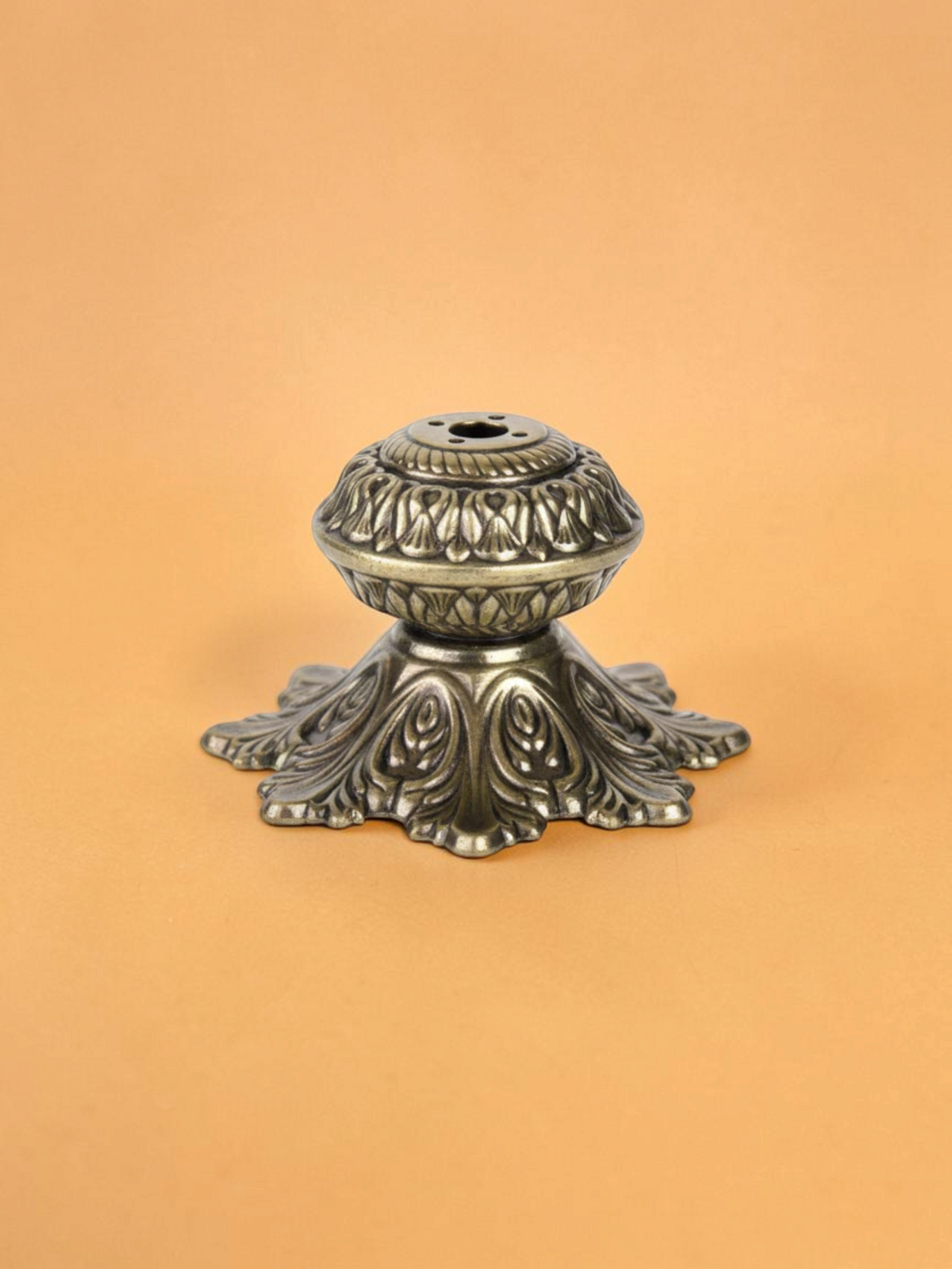 Rigvedaa™ handcrafted solid brass agarbatti stand with an intricate floral petal base and antique golden finish.