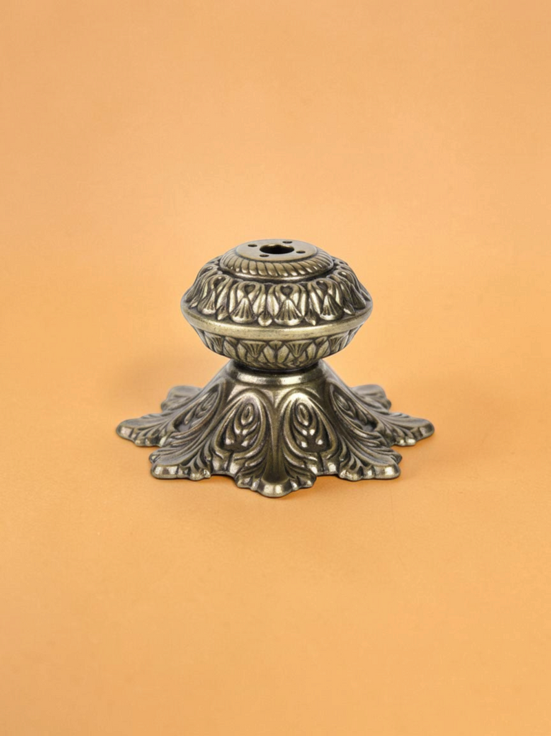 Rigvedaa™ handcrafted solid brass agarbatti stand with an intricate floral petal base and antique golden finish.