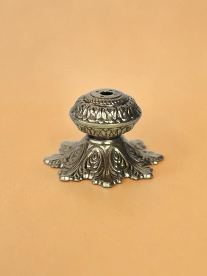 Rigvedaa™ solid brass agarbatti stand featuring an intricately carved floral petal base with an antique golden finish.