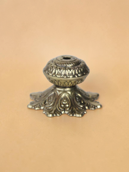 Rigvedaa™ handcrafted solid brass agarbatti stand with an intricate floral petal base and antique golden finish.