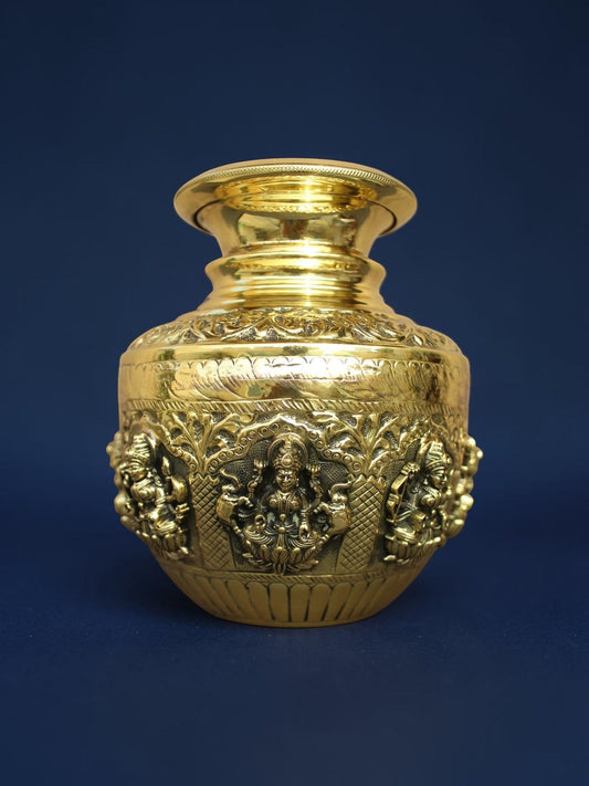 Rigvedaa™ handcrafted brass Ashta Lakshmi kalash pot with intricate embossed deity carvings and polished gold finish.