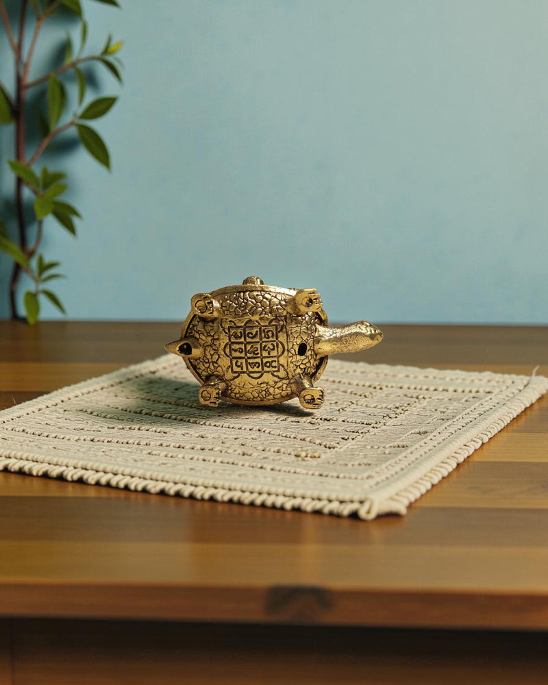 Rigvedaa	rade	rade brass tortoise with Shree Yantra and Ashta Lakshmi carvings, golden patina, intricate details.
