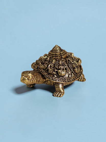 Rigvedaa™ brass Ashta Lakshmi tortoise figurine featuring intricate engravings and a central Shree Yantra on the shell.