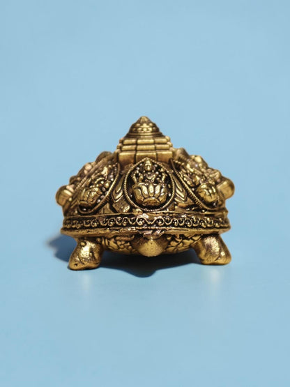 Rigvedaa™ brass Ashta Lakshmi tortoise featuring an engraved Shree Yantra on its shell with a warm golden patina.