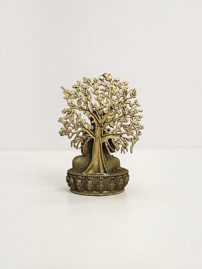 Back view of a Rigvedaa™ brass Buddha statue showing the intricate openwork Bodhi tree canopy and ornate lotus base.