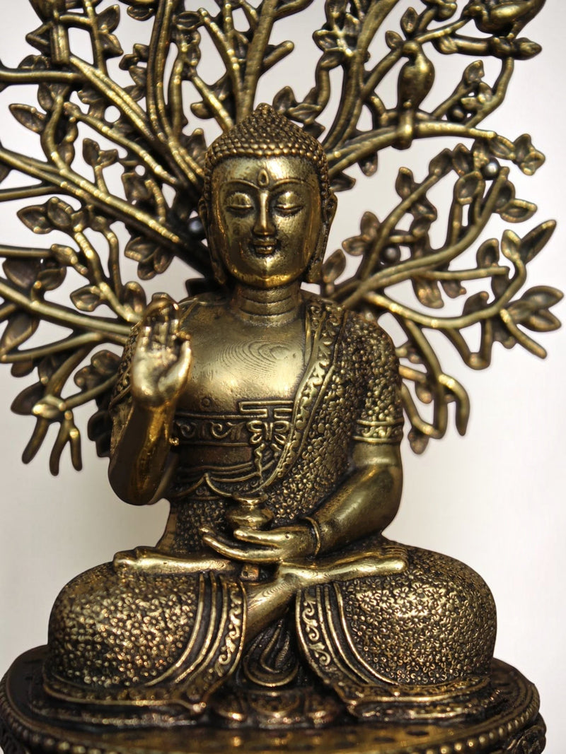 Rigvedaa™ brass Buddha statue in meditation pose under a detailed Bodhi tree canopy with an antique gold finish.