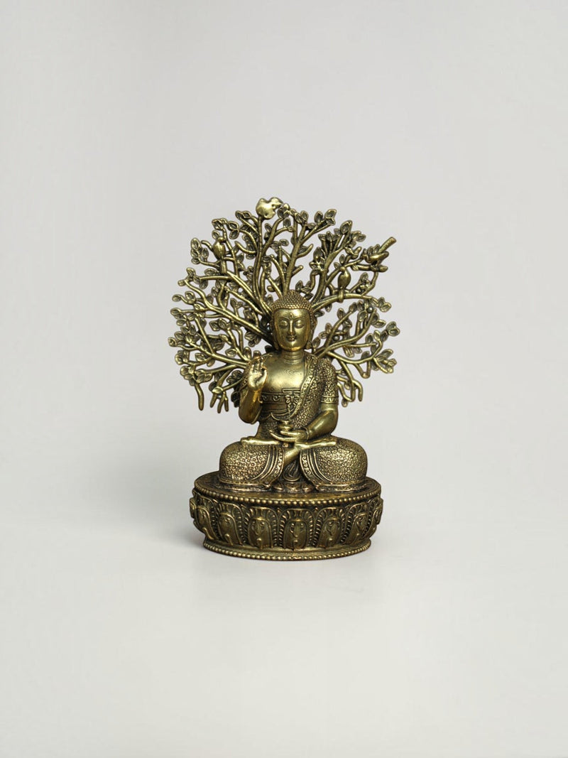 Rigvedaa™ brass Buddha statue in meditation pose under a detailed Bodhi tree canopy with an antique gold finish.