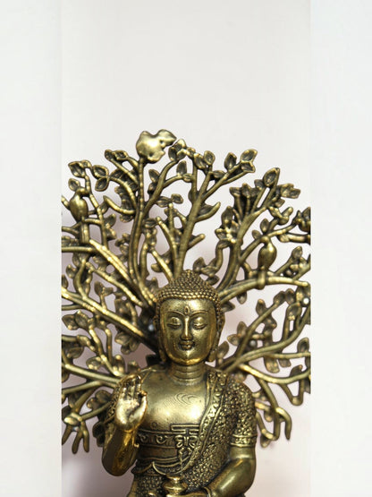 Rigvedaa™ brass Buddha statue in meditation pose under an intricate Bodhi tree canopy with an antique gold finish.