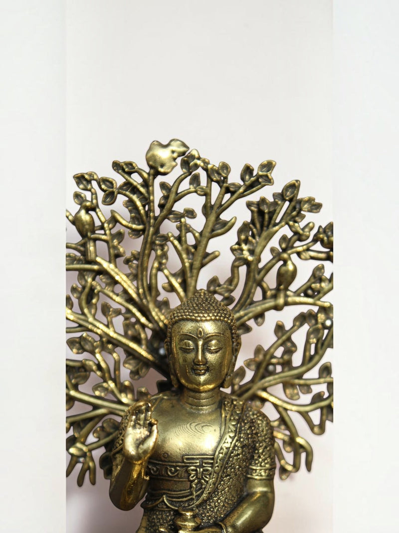 Rigvedaa™ brass Buddha statue in meditation pose under an intricate Bodhi tree canopy with an antique gold finish.