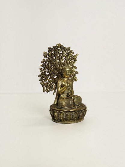 Rigvedaa™ brass Buddha statue in meditation pose under a Bodhi tree with an antique gold finish on a lotus base.