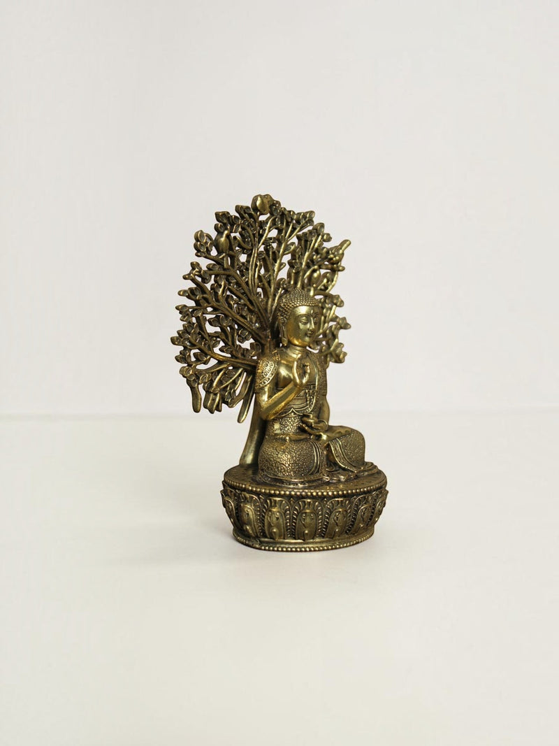Rigvedaa™ brass Buddha statue in meditation pose under a Bodhi tree with an antique gold finish on a lotus base.