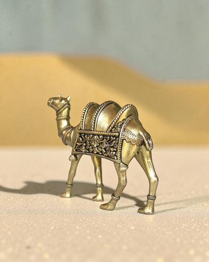 Rigvedaa™ golden brass camel statue with intricate saddle detailing, a symbol of desert heritage and good fortune.