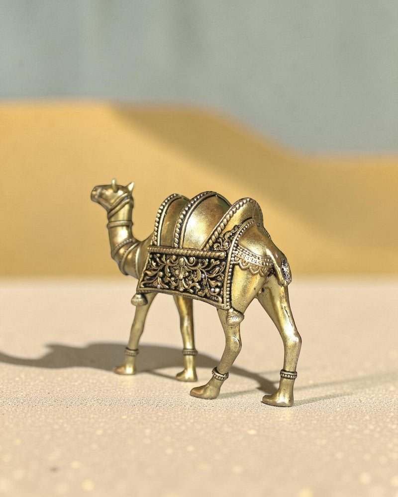 Rigvedaa™ golden brass camel statue with intricate saddle detailing, a symbol of desert heritage and good fortune.