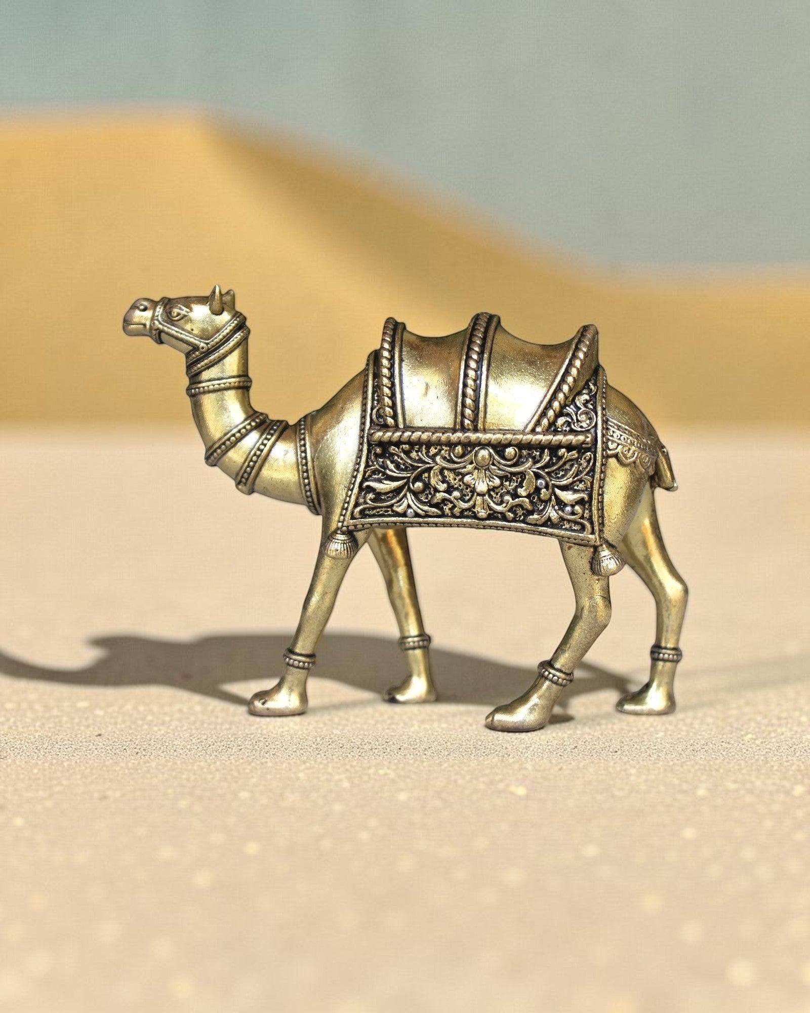 Rigvedaa™ brass desert camel statue with intricate saddle details, a symbol of Rajasthani heritage and good fortune.