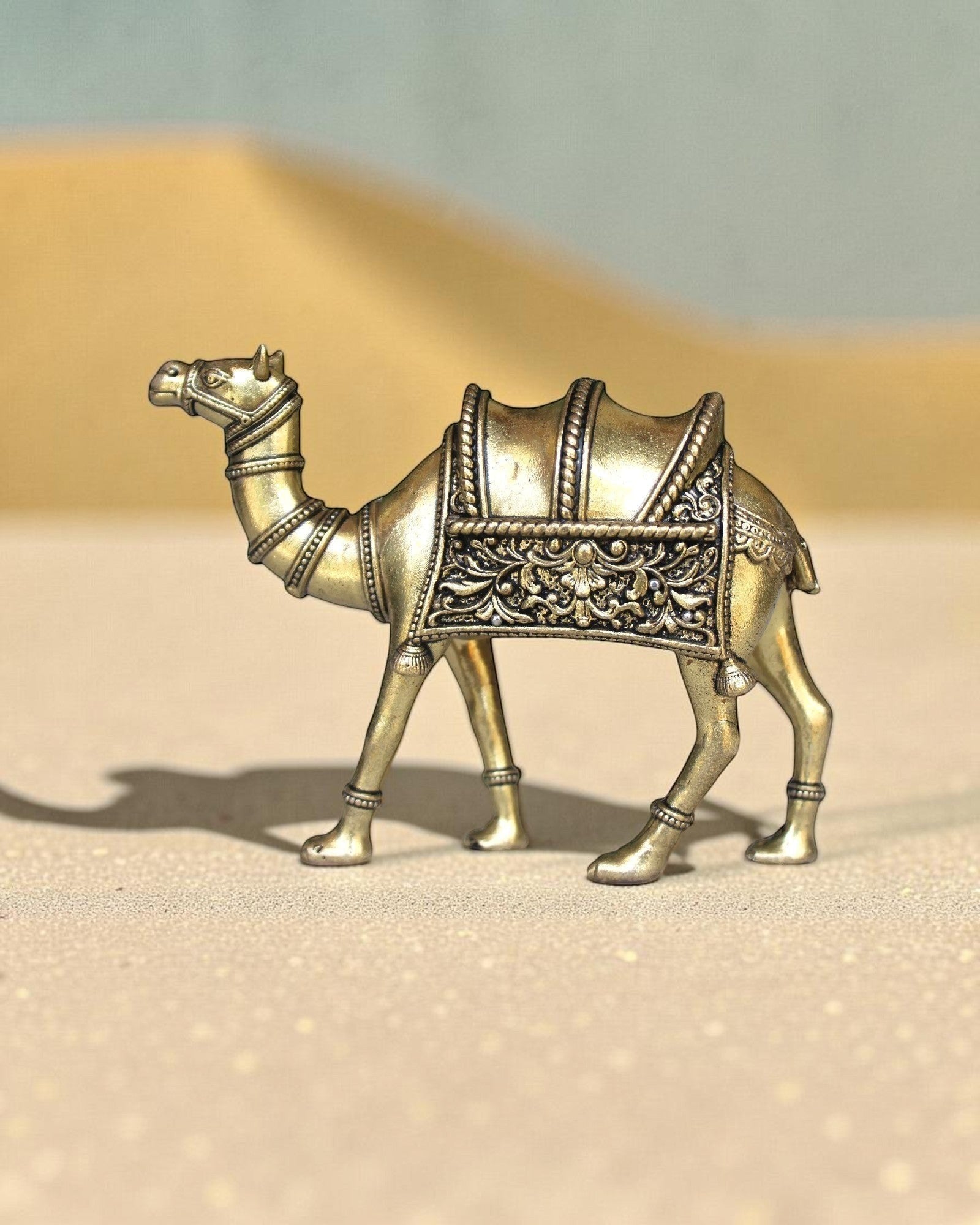 Rigvedaa™ brass desert camel statue with intricate saddle details, a symbol of Rajasthani heritage and good fortune.