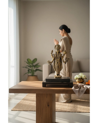 Rigvedaa brass Lord Dhanvantri idol, God of Ayurveda, holding a pot and herbs, on a dark base.