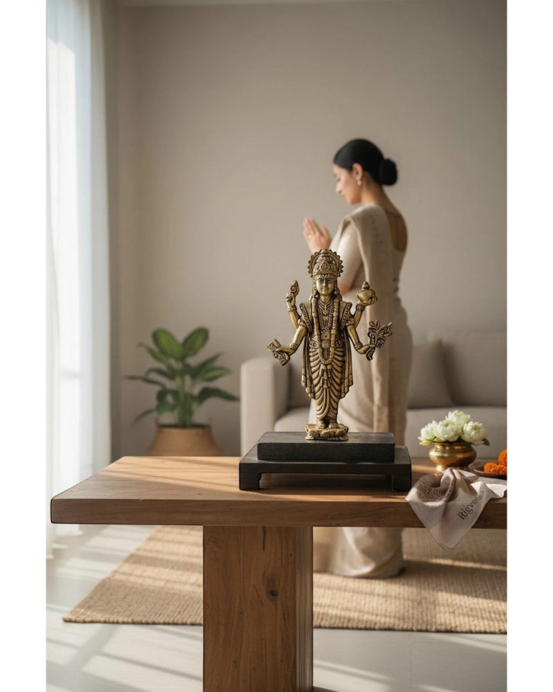 Rigvedaa brass Lord Dhanvantri idol, God of Ayurveda, holding a pot and herbs, on a dark base.