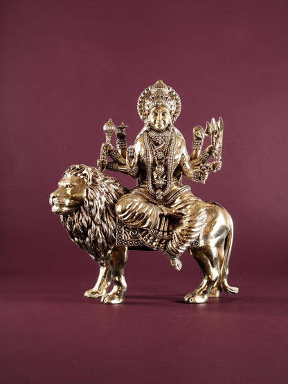 Rigvedaa™ 12-inch brass Goddess Durga statue seated on a lion, featuring intricate detailing and golden patina finish.