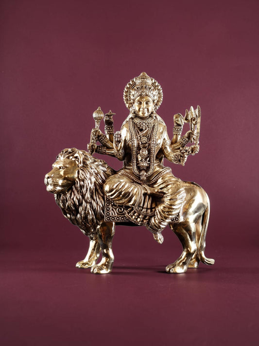Rigvedaa™ 12-inch brass Goddess Durga statue seated on a lion, featuring intricate detailing and golden patina finish.