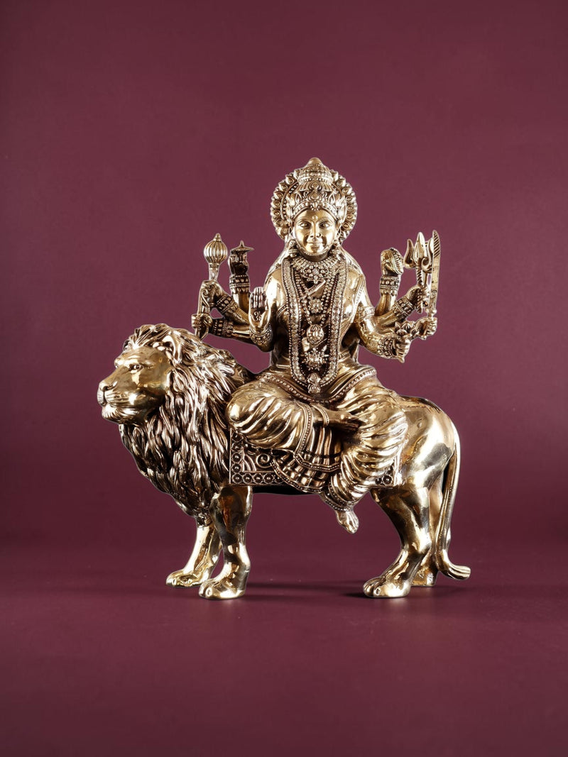 Rigvedaa™ 12-inch brass Goddess Durga statue seated on a lion, featuring intricate detailing and golden patina finish.