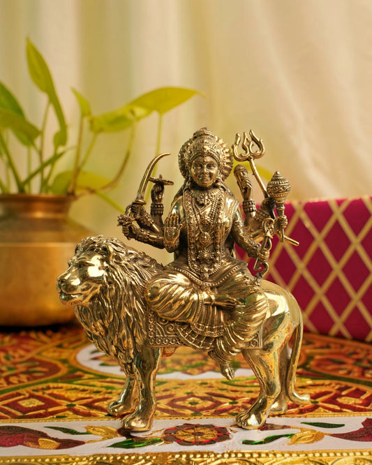 Rigvedaa	rade	rade brass Durga seated on lion murti, holding weapons and in Abhaya Mudra.