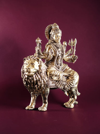 Rigvedaa™ 12-inch brass Goddess Durga statue seated on a lion, featuring intricate gold-toned metal craftsmanship.
