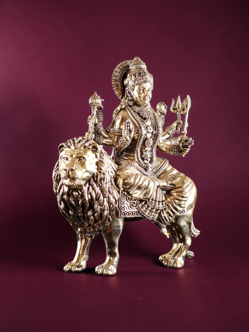 Rigvedaa™ 12-inch brass Goddess Durga statue seated on a lion, featuring intricate gold-toned metal craftsmanship.
