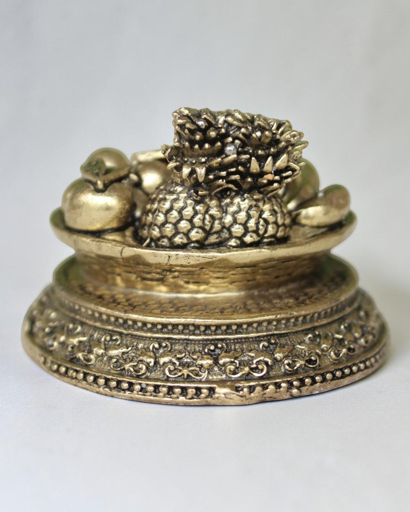 Rigvedaa™ antique brass miniature fruit basket idol with ornate pedestal, symbolizing prosperity. 1.50 inch.
