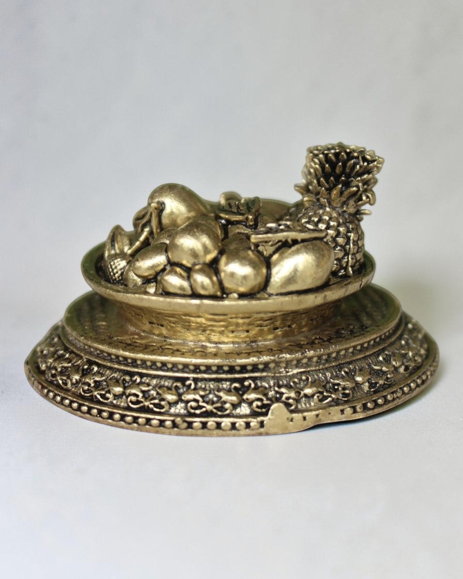 Rigvedaa™ antique gold brass miniature fruit basket idol with ornate pedestal base, symbol of prosperity and abundance.