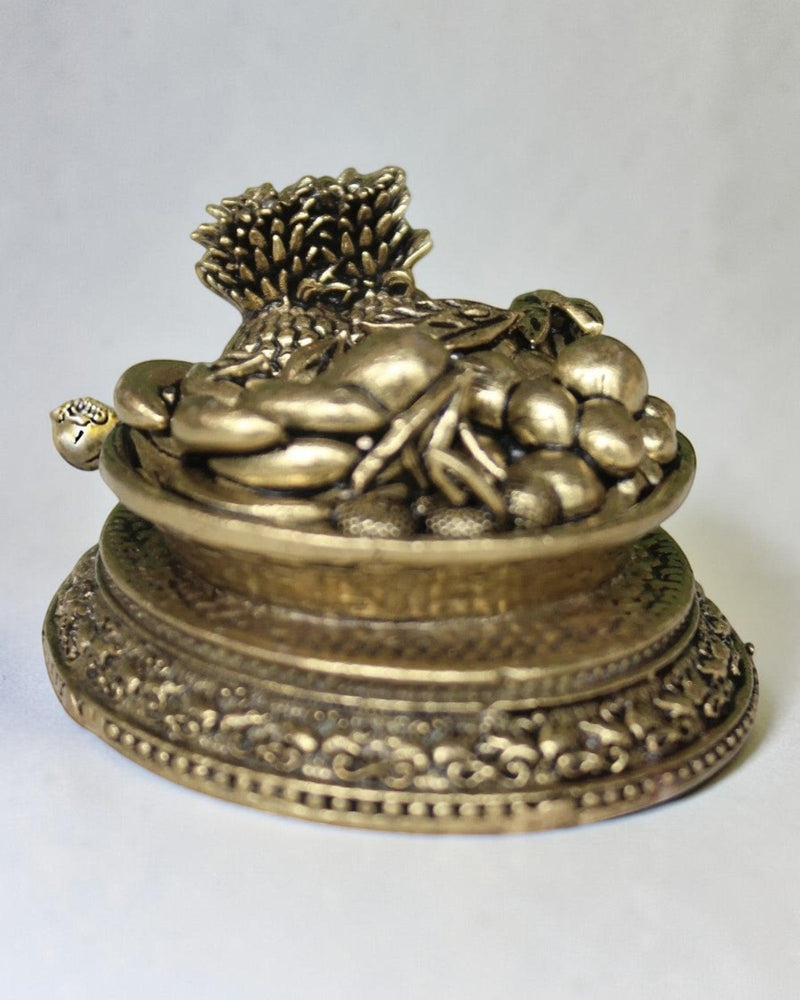 Rigvedaa™ antique brass miniature fruit basket idol with ornate pedestal base, symbolizing abundance and prosperity.