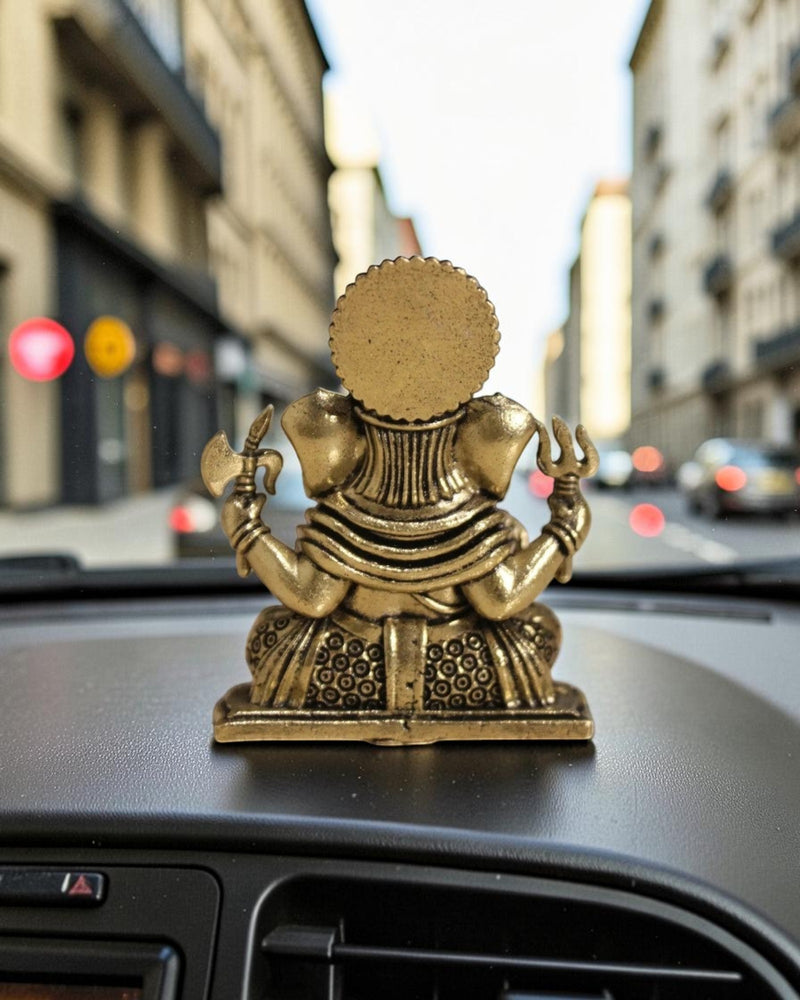 Rigvedaa™ brass Ganesha idol with intricate details, seated pose, holding axe and trident. For car dashboard.