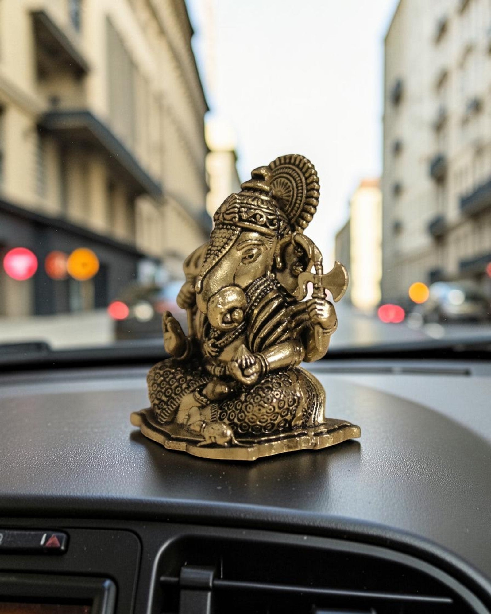Rigvedaa™ brass Ganesha idol for car dashboard, detailed golden finish, seated pose, for good luck and protection.