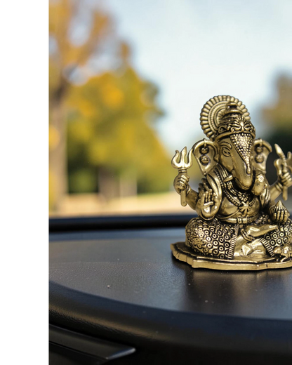 Rigvedaa™ brass Ganesha idol for car dashboard, detailed golden finish, holding trident, for good luck and protection.