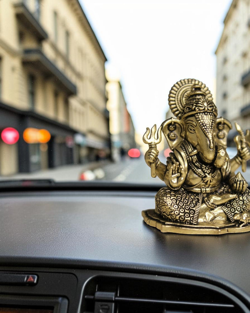 Rigvedaa™ brass Ganesha idol for car dashboard, detailed golden finish, holding trident, for good luck and protection.